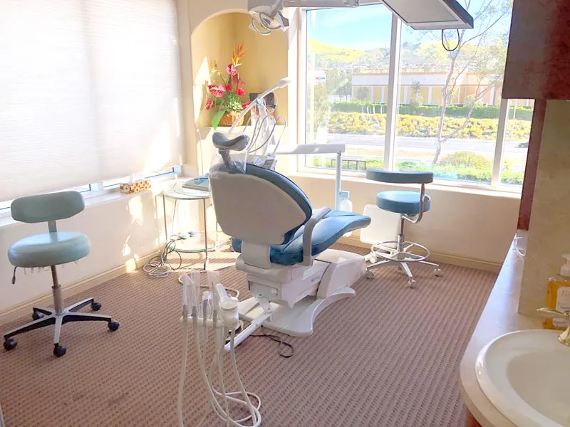 Sunlit treatment room with a view of the Lake Forest foothills at Baker Ranch Dental Spa